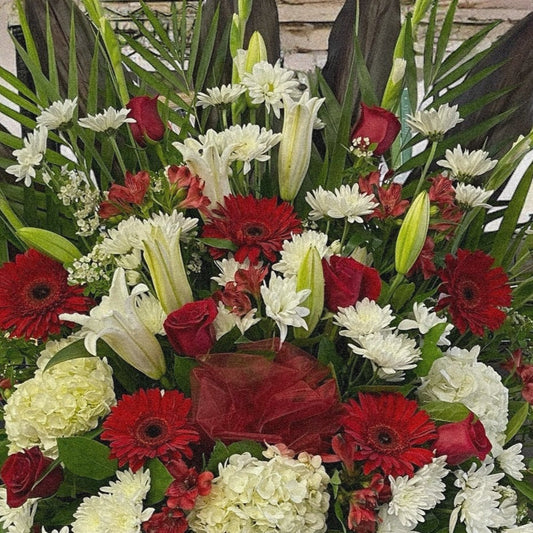 Majestic Harmony funeral arrangement with red, white, green blooms; luxury sympathy flowers, best in Toronto & GTA, same day delivery.