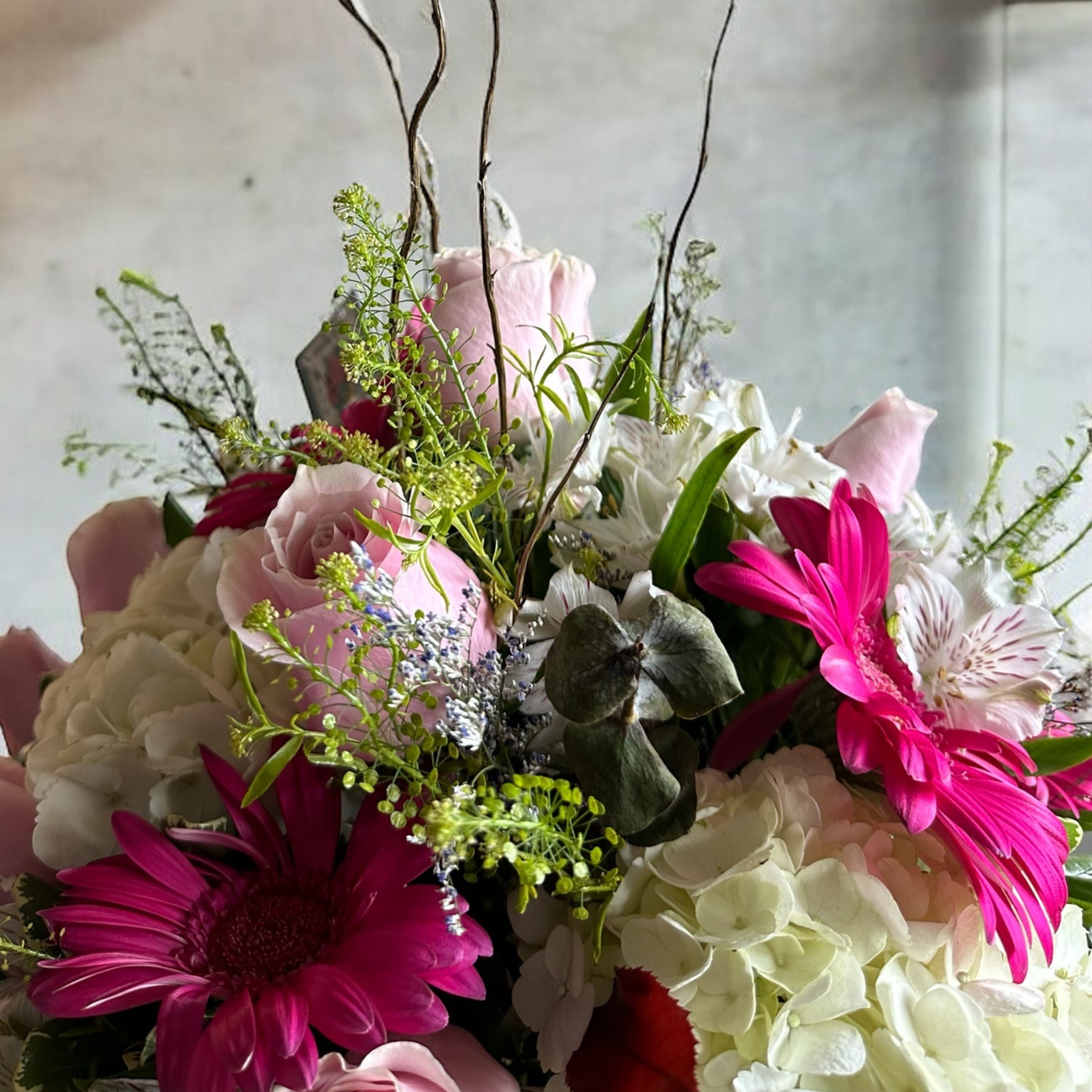 Blushing Elegance floral arrangement with pink roses and gerberas in a golden vase, ideal for Toronto's luxury flowers.