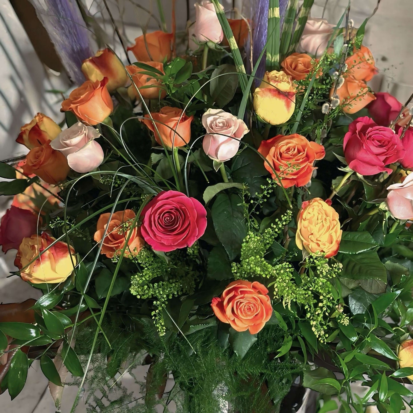 Handcrafted assorted rose bouquet and eucalyptus, symbolizing eternal love and admiration.