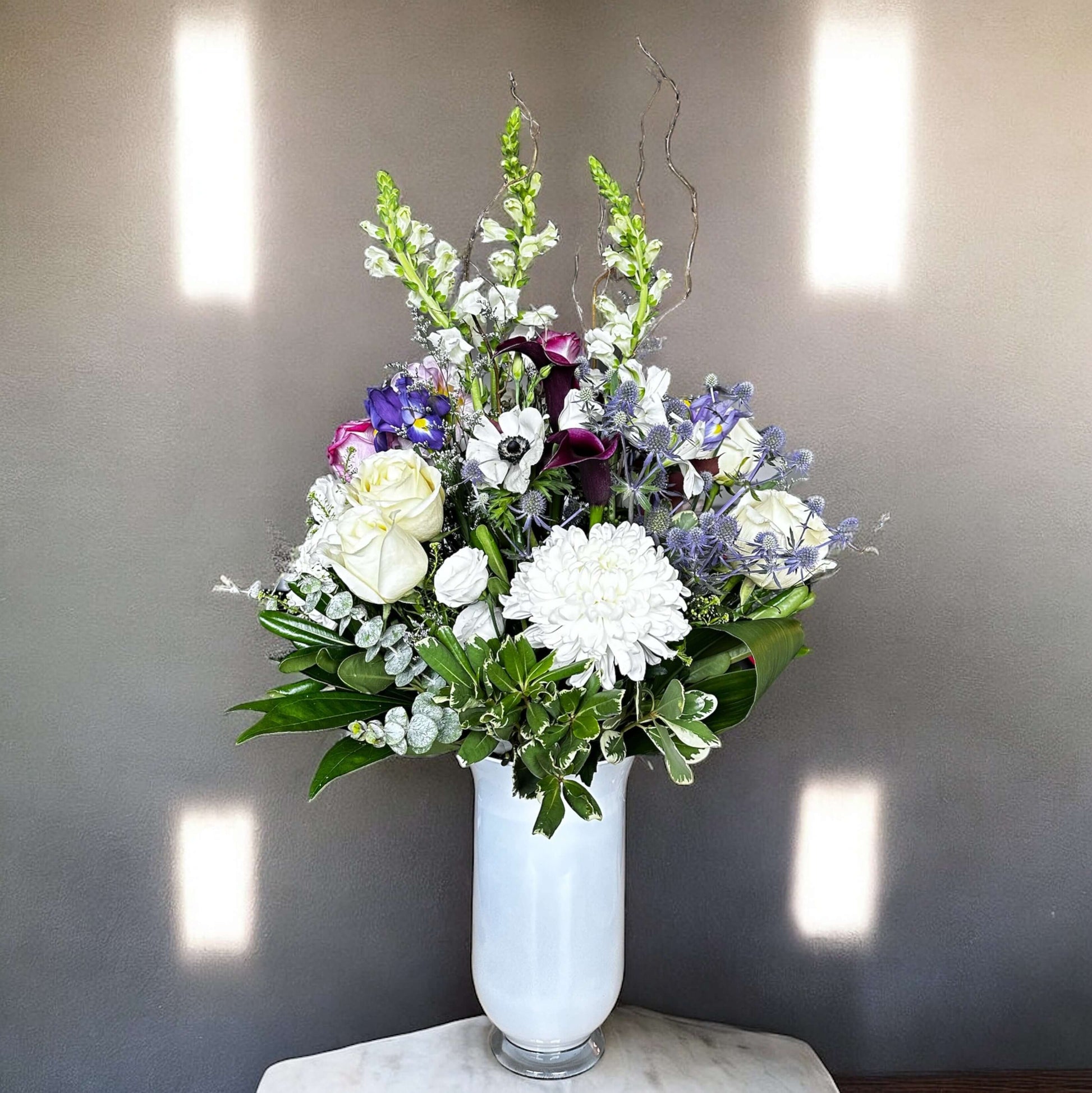 Aster Elegance Bouquet with white roses and purple flowers in a vase, luxury arrangement by best Toronto and GTA florist, fresh and elegant.