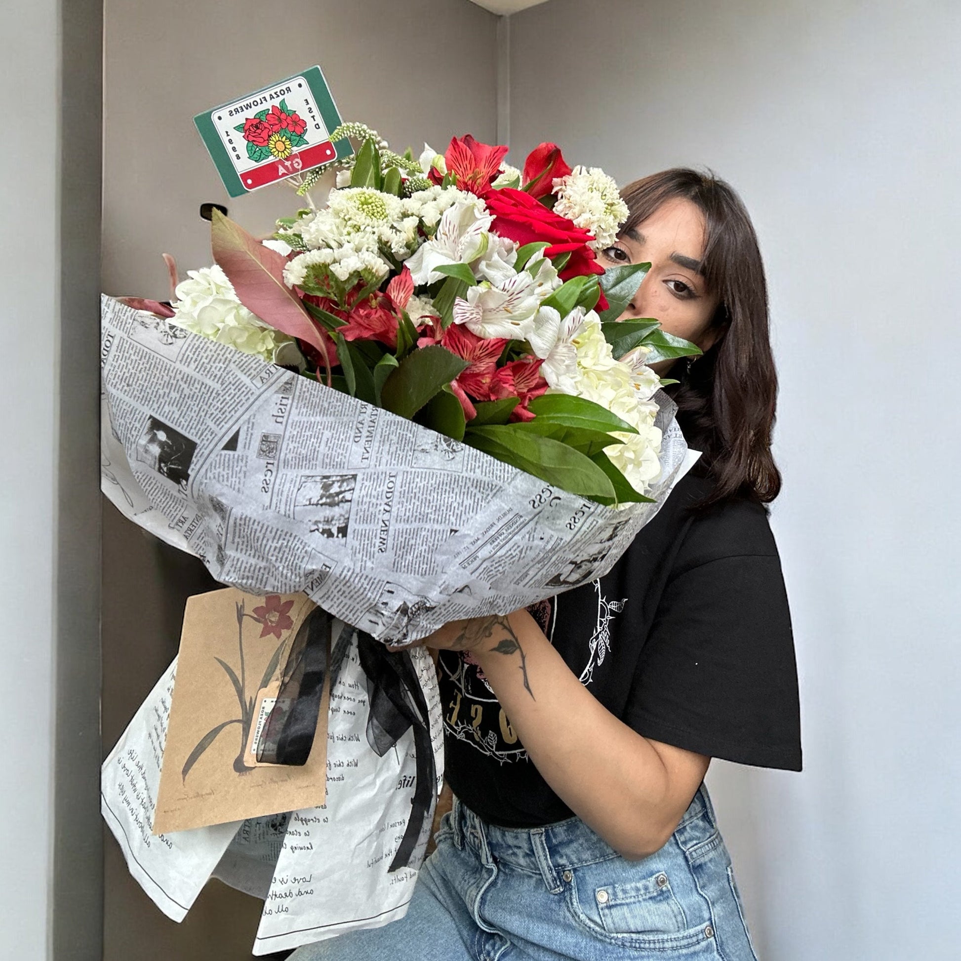 Handcrafted rose bouquet with delicate orchids and eucalyptus, symbolizing eternal love and admiration.