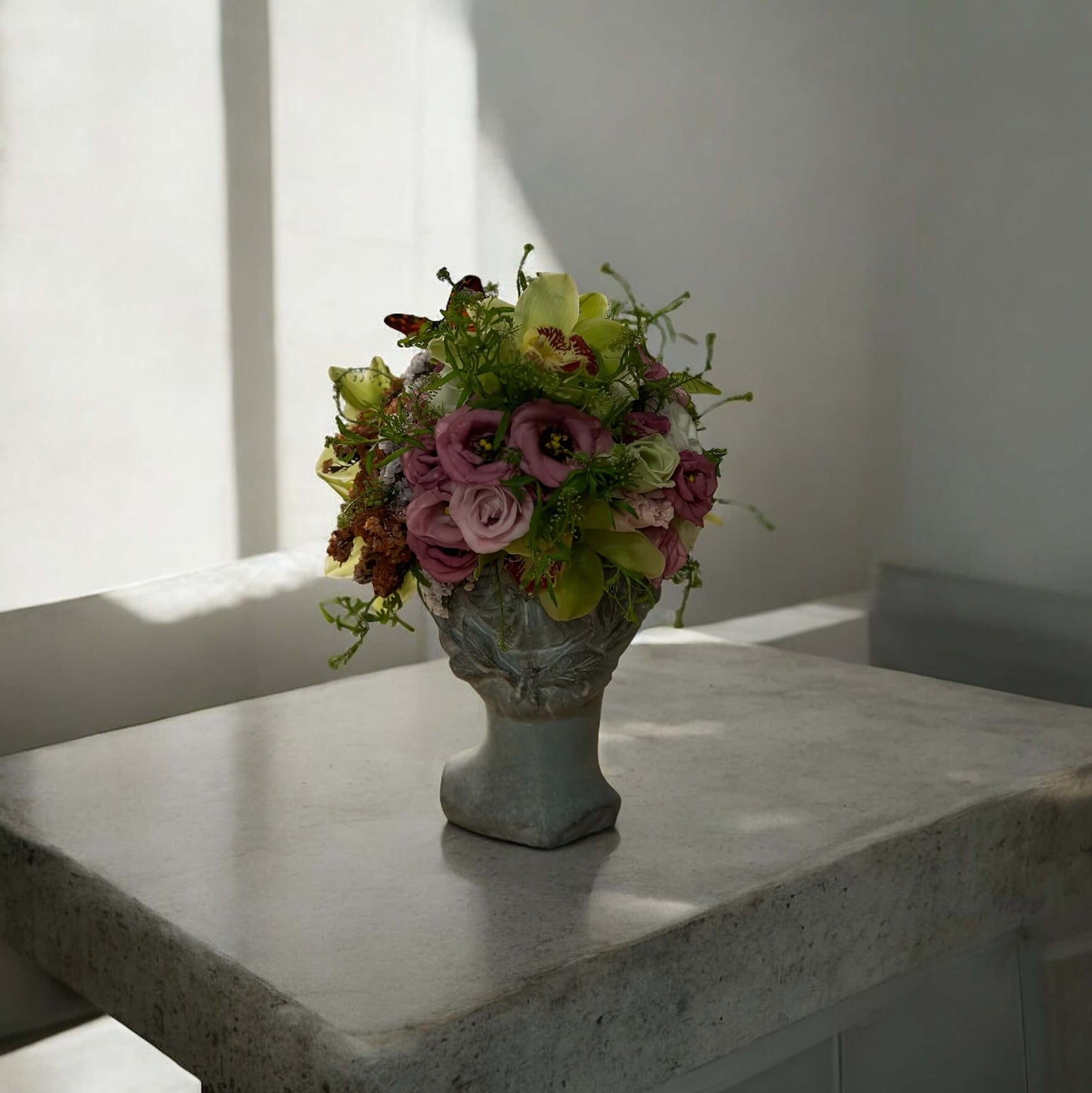 Chic and modern floral centerpiece with delicate orchids, perfect for sophisticated home or event decor.