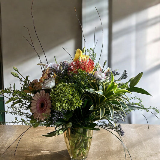 Autumn-inspired bouquet with warm-toned chrysanthemums, sunflowers, and seasonal foliage