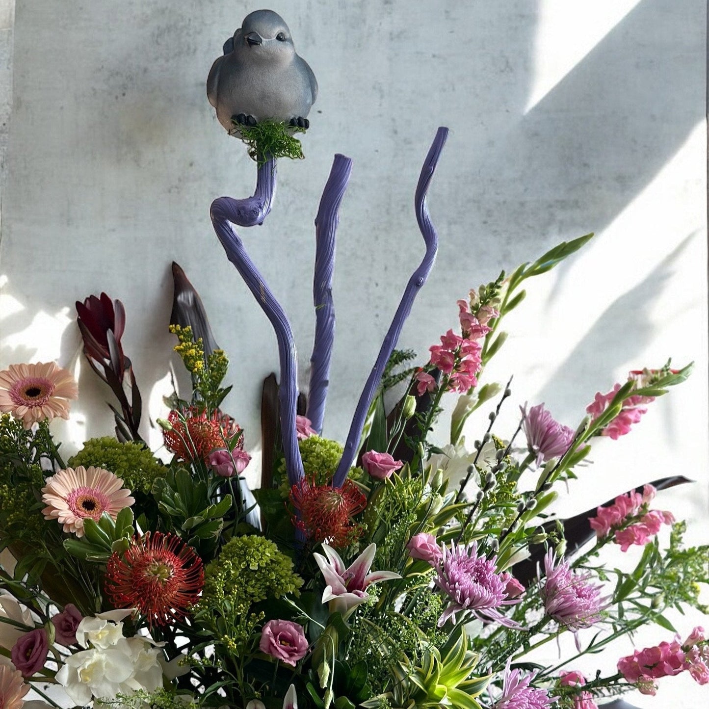 Classic sympathy flower basket featuring white lilies, hydrangeas, and soft greenery, offering warmth and condolence.